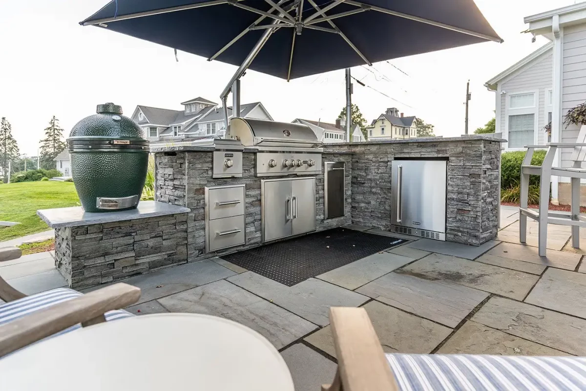 L-Shape Stacked Stone Outdoor Kitchen With Smoker